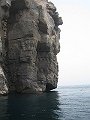  Steep rock, with lots of coral on the wall under water!