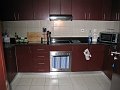  Kitchen, seen from the entrance from the hall. Sink is to the right, bar to living room to the left