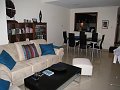  Living room seen from balcony door, kitchen bar in the back, entrance hall in the back right